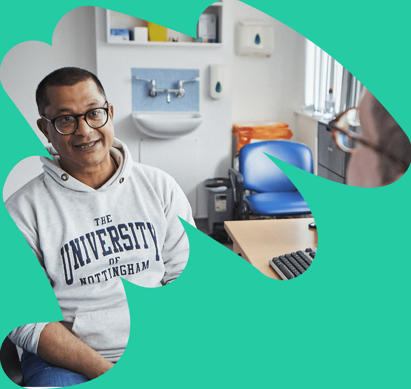 South Asian man sat talking to a clinician in a medial consultation room