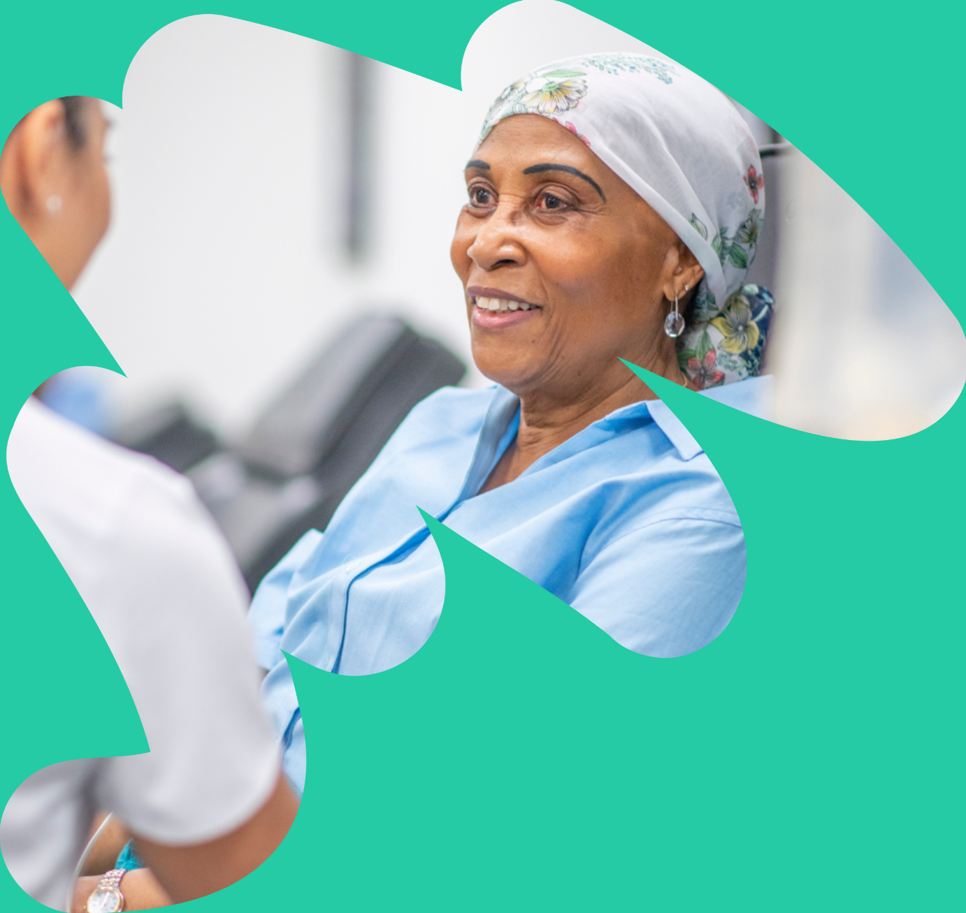 Mature woman wearing a headscarf receiving care from a nurse in a hospice