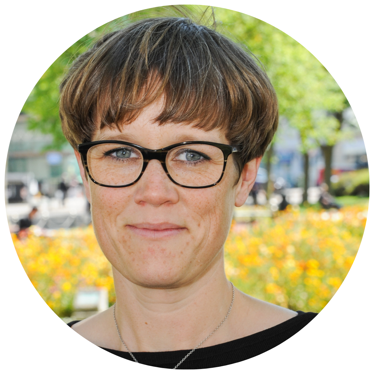 Jo Crease headshot, a white woman wearing glasses smiling at the camera