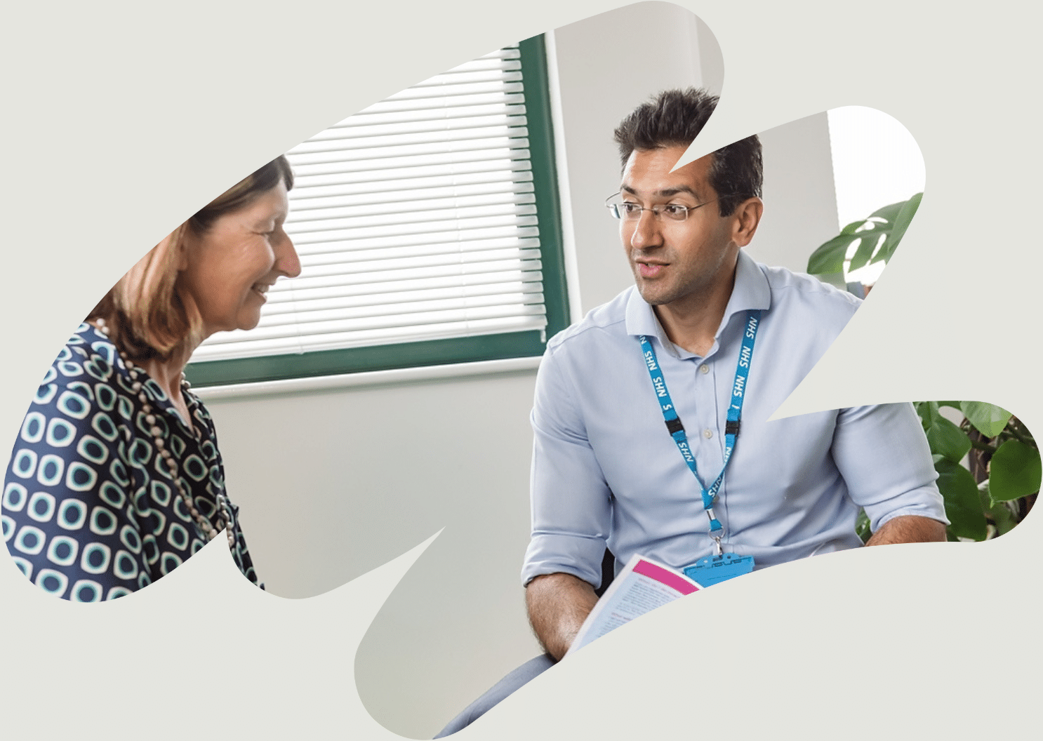 South Asian man sat talking to a clinician in a medial consultation room