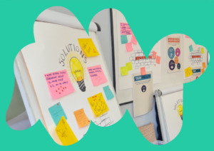 ROH Header Image A Rethinking Our Health workshop space featuring flipcharts and whiteboards covered in colourful sticky notes. One flipchart is labelled "SOLUTIONS" with a hand-drawn lightbulb in the centre, surrounded by ideas on post-it notes. In the background, posters titled "YOUR HEALTH" and "BARRIERS" are visible, with more sticky notes and diagrams. The image is framed by an abstract teal shape.