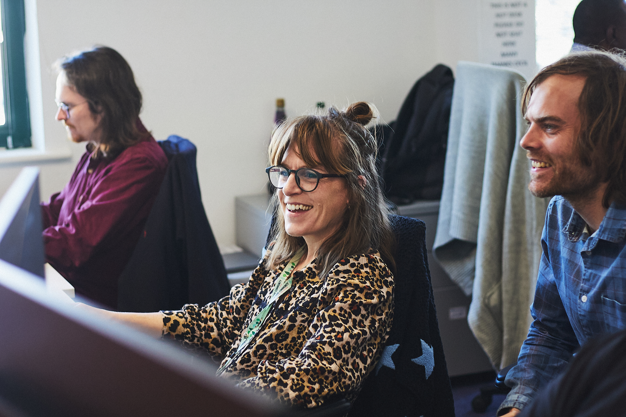 Two people looking at a computer screen smiling