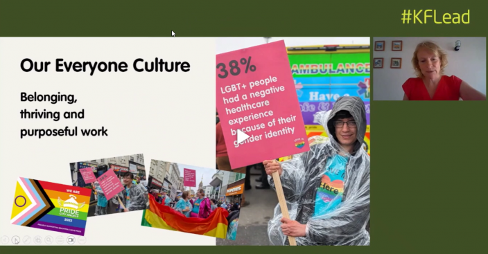 Screenshot of conference with Una speaking picturing Here employee holding a banner at Brighton Pride.